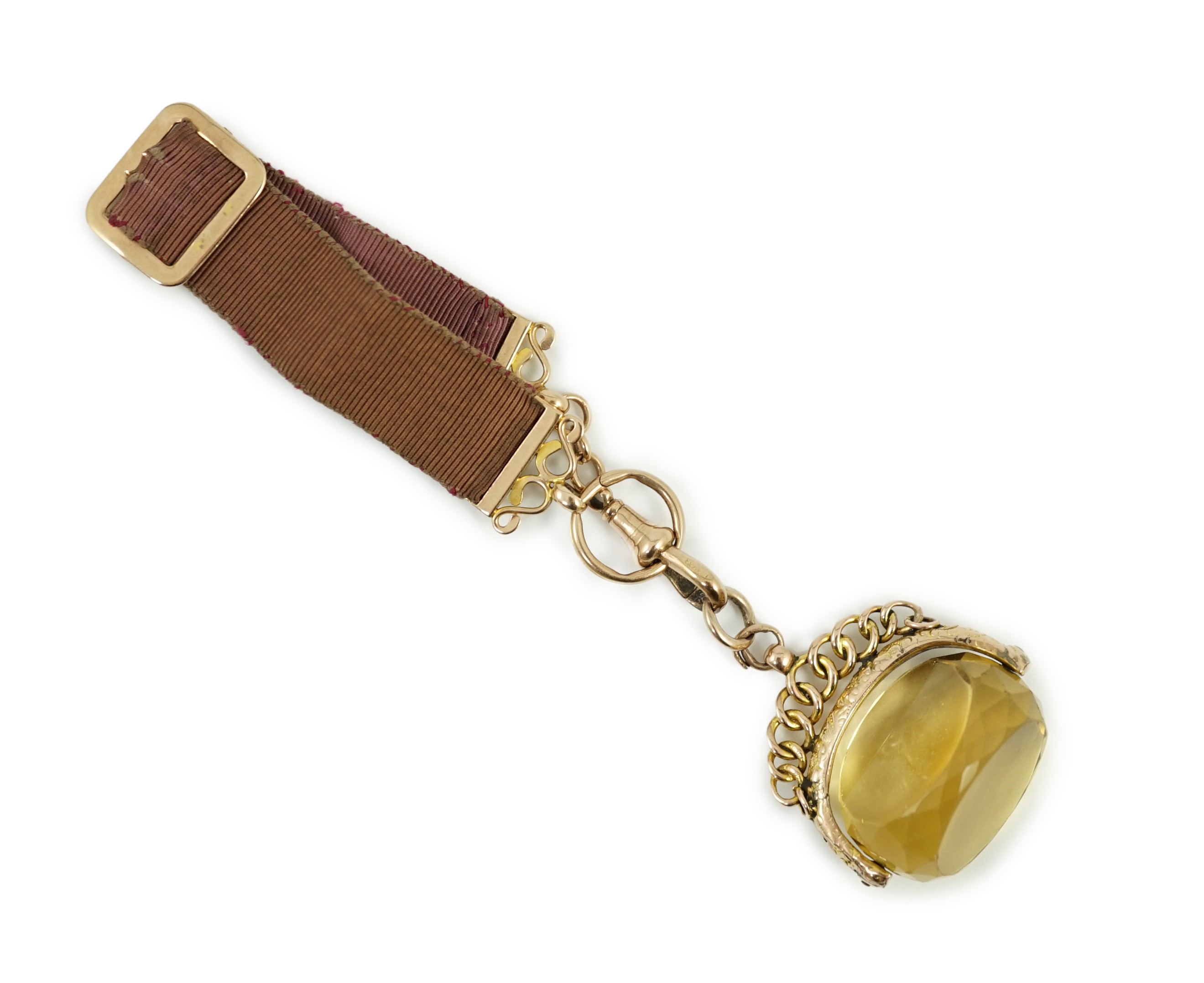 A late Victorian yellow metal and citrine set spinning fob, width 37mm, on a yellow metal mounted suspension sash, gross weight 31.6 grams.